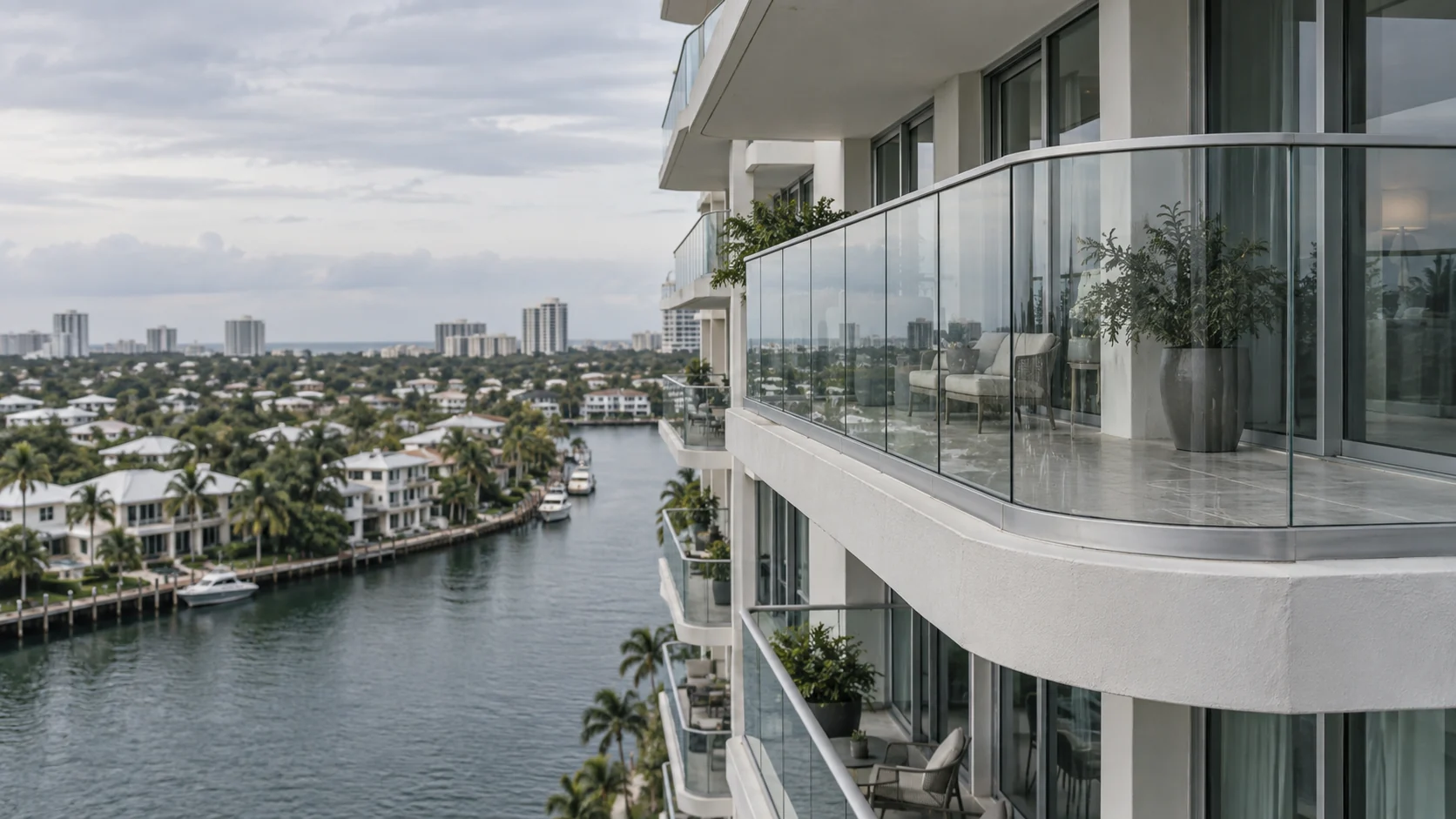 Curved glass balcony railings on a South Florida high-rise above the waterway