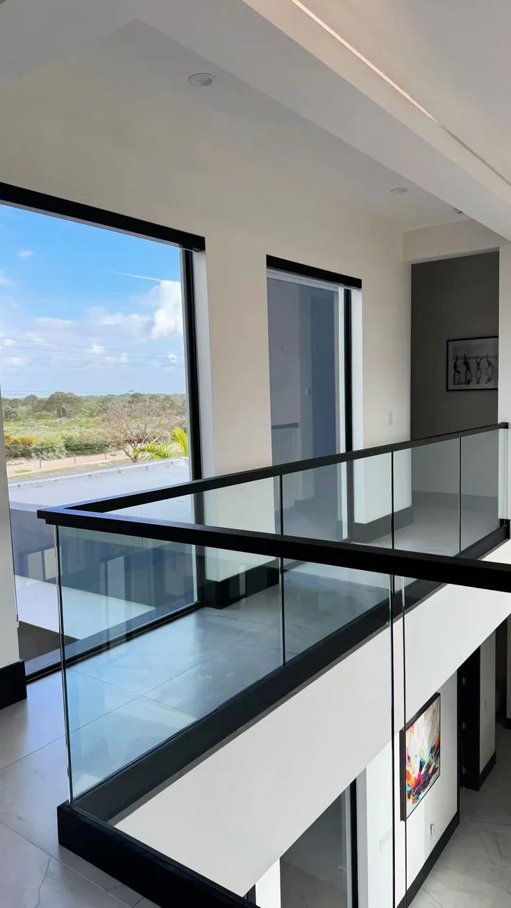 A black top rail around an upper landing