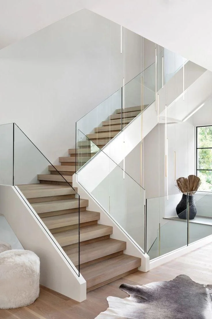Frameless glass along a white oak stair