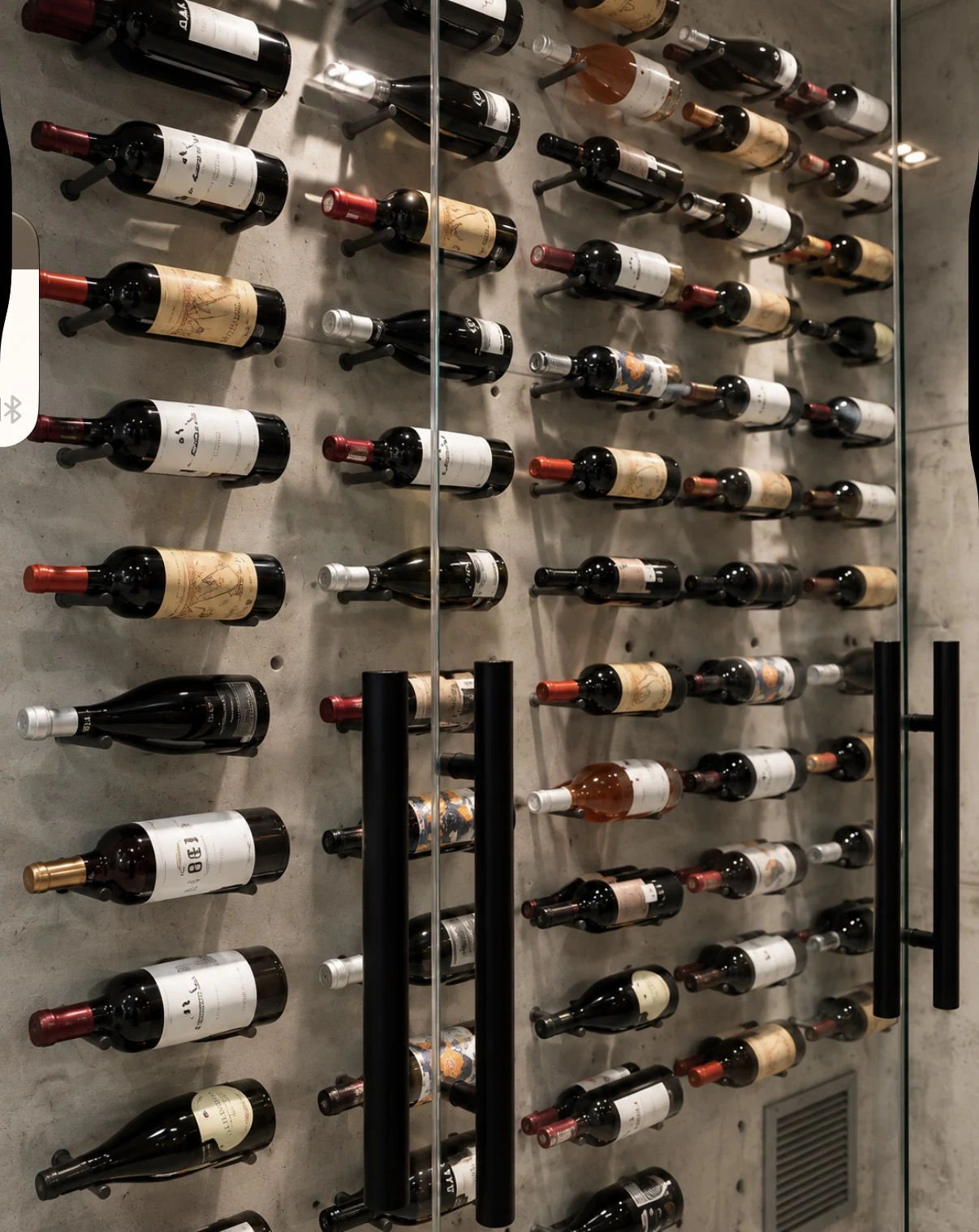 Bottles behind a glass wine wall