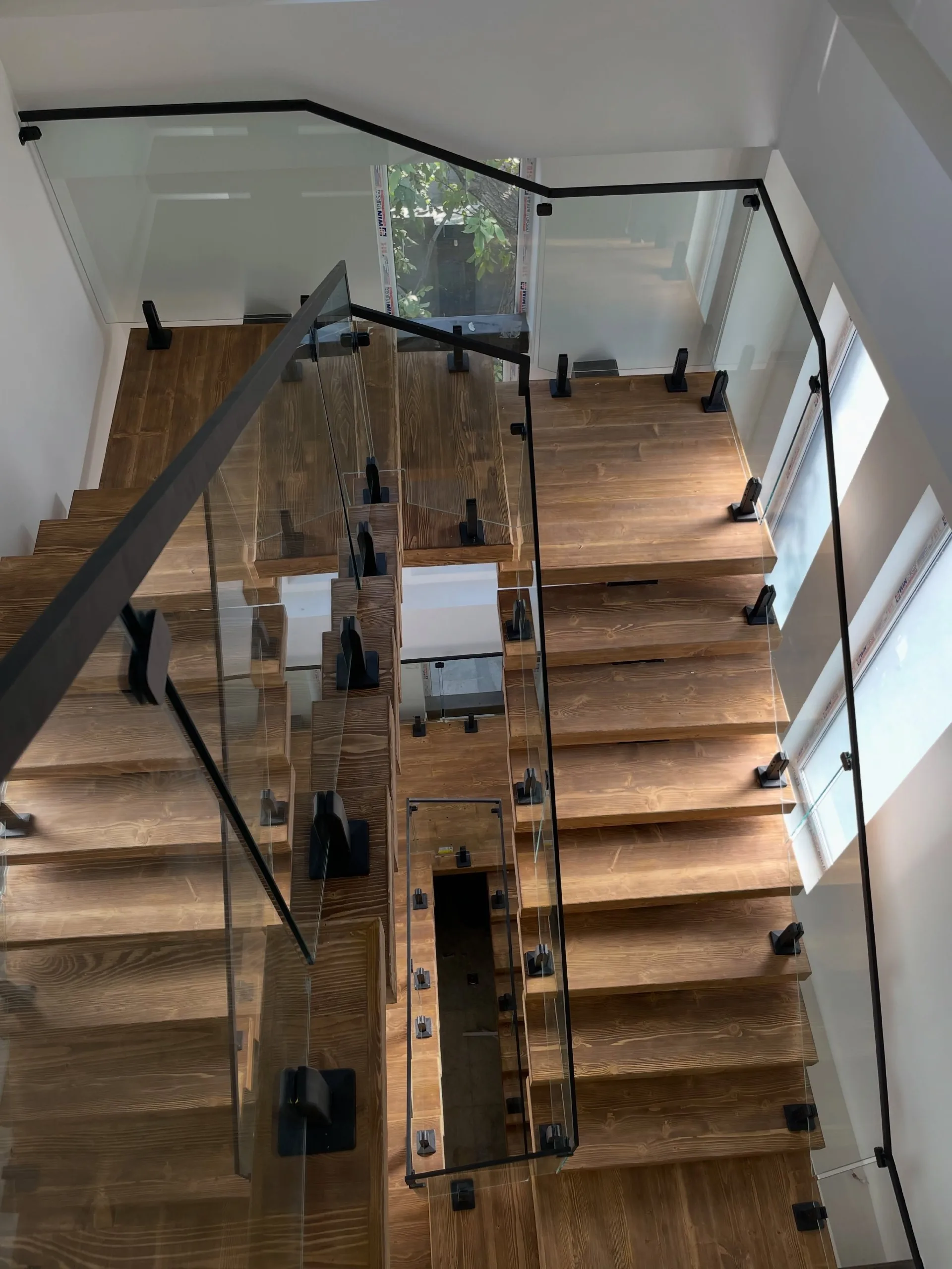 Glass railings down a switchback stair